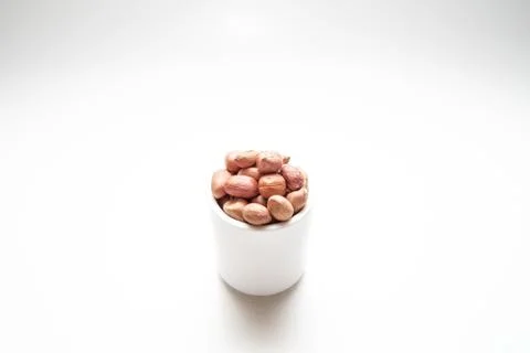 Peanuts in small cups isolated on white background Stock Photos