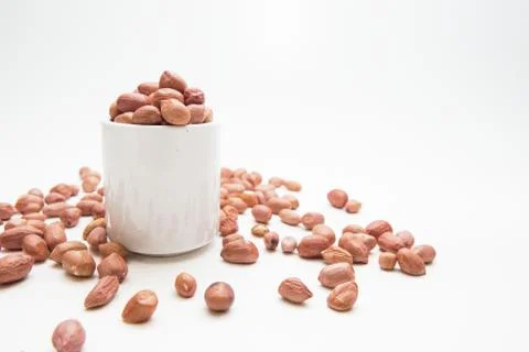 Peanuts in small cups isolated on white background Stock Photos