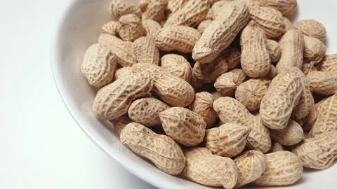 Peanuts spinning inside a white ceramic bowl. Stock Footage 160929632
