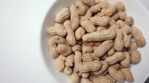 Peanuts spinning inside a white ceramic bowl. Stock Footage 160929689