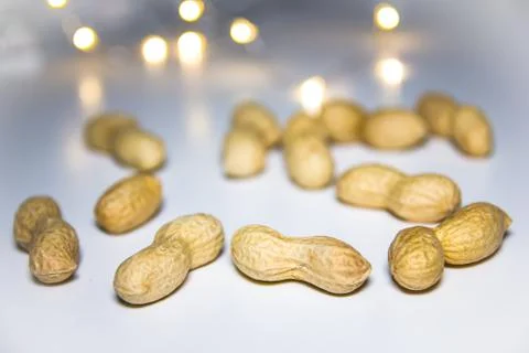Peanuts on a white background with blurred lights Stock Photos
