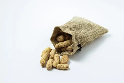 Peanuts on a white background. Peanuts in a small bag.  Stock Photos