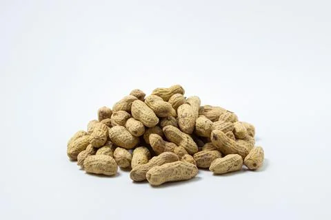 Peanuts on a white background. A small pile of peanuts. Stock Photos