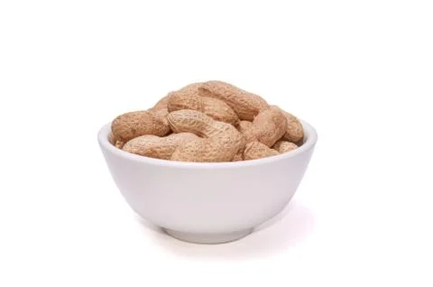 Peanuts in a white cup on a white background Stock Photos