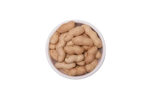 Peanuts in a white cup on a white background Stock Photos