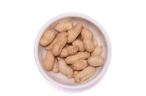 Peanuts in a white cup on a white background Stock Photos