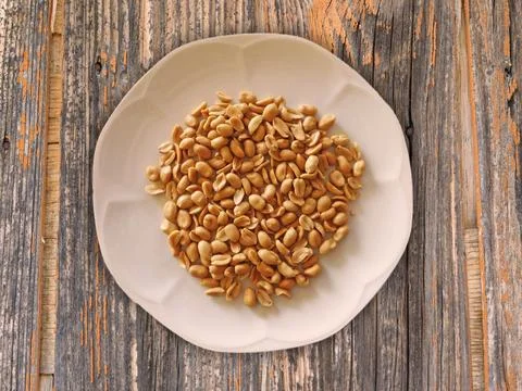 Peanuts on wood texture Stock Photos