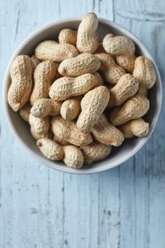 Peanuts on wooden background Stock Photos