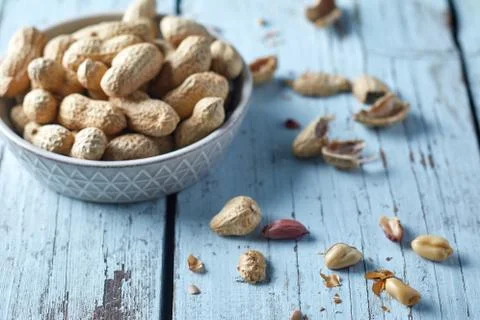 Peanuts on wooden background Stock Photos