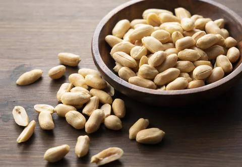 Peanuts on a wooden table. Stock Photos