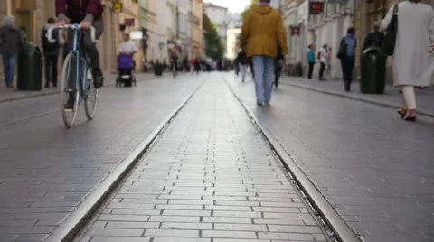 Peaople walking on the old pavement with old railroad. Timelaps. Stock Footage 61126850
