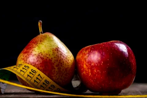 Pear and apple representing types of overweight Stock Photos
