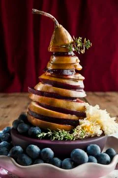 A pear and beetroot tower with grated cheese and blueberries Stock Photos
