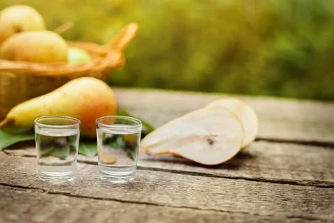 Pear brandy and pears on the table Stock Photos