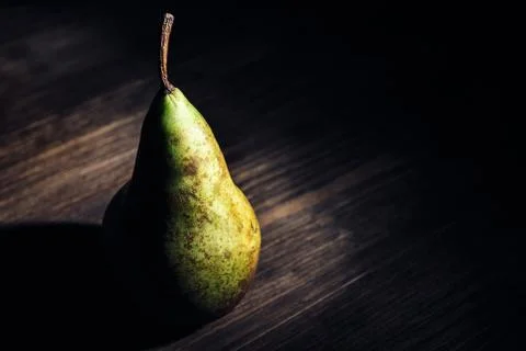 Pear on a dark wood rustic table Stock Photos