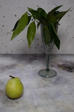Pear in front of leaves, on light background Stock Photos