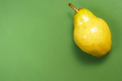 A pear on the green background. Stock Photos