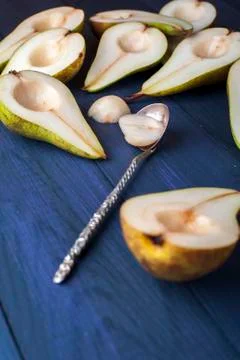 The pear halves with spoon on table Stock Photos