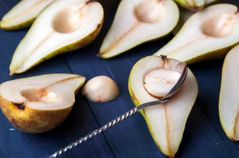 The pear halves with spoon on table Stock Photos