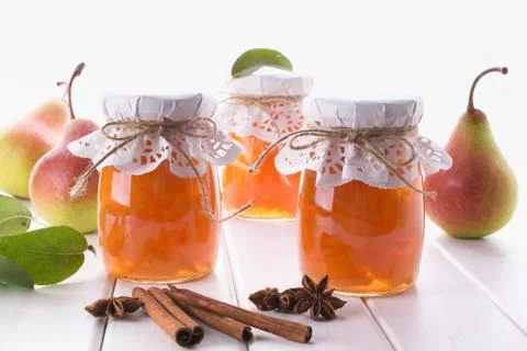 Pear jam and fresh pears cinnamon sticks, anise stars and green  leaves Stock Photos