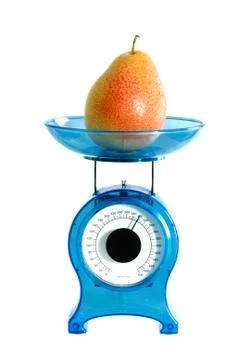 Pear on kitchen scale Stock Photos