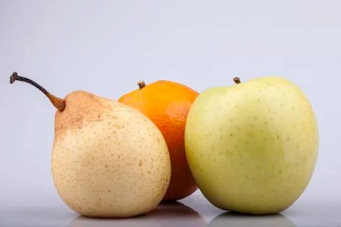 Pear, orange and apple on white background Stock Photos