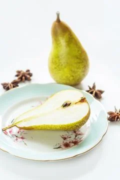 Pear on a plate, light background Stock Photos