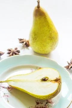 Pear on a plate, light background Stock Photos