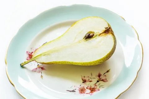 Pear on a plate, light background Stock Photos