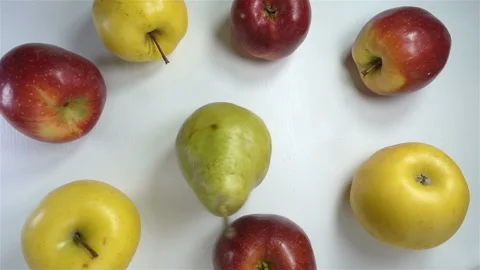 Pear rotates in a circle of apples in slow motion Stock Footage 142070240