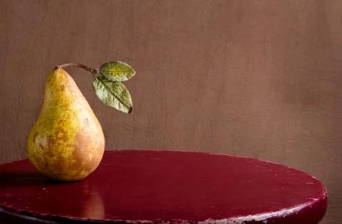 Pear on a rustic stool Stock Photos