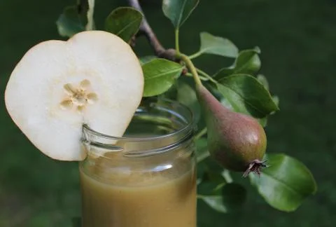 Pear sauce in front of a pear tree Stock Photos
