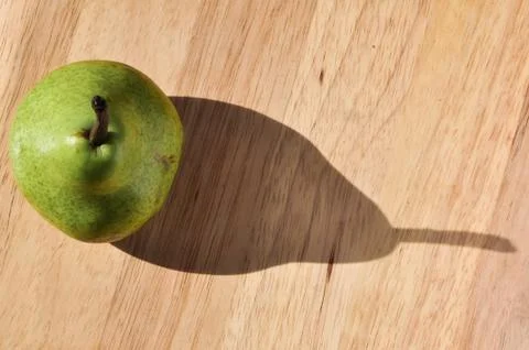 Pear with Shadow on Cutting Board Stock Photos