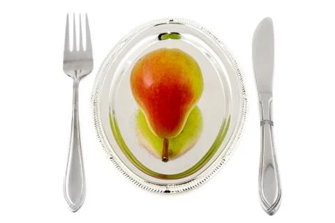 	Pear on a silver plate Stock Photos
