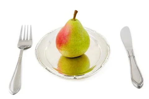 	Pear on a silver plate Stock Photos