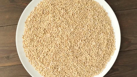 Pearl barley rotating on a plate. Video stock 328572307