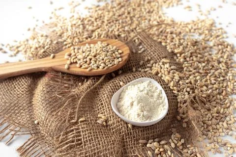 Pearl barley on a white background isolate. Healthy eating porridge on a wooden Stock Photos