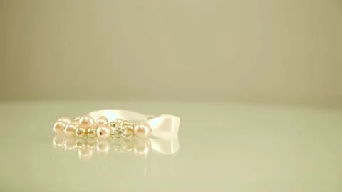 Pearl bracelet isolated. Pearl thread. Bracelet of pink pearls on a white Stock Footage 133290833