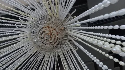Pearl on the chandelier with long dangling threads Stockbeeldmateriaal 319031930