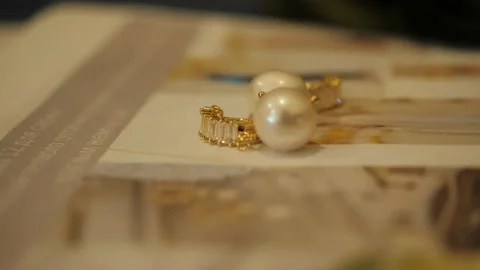 Pearl earrings are on the table Stock Footage 140908564