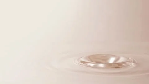 Pearlescent Liquid Drop Falling, Creating Ripples in Slow Motion, Cosmetic Cream Видео 346415808