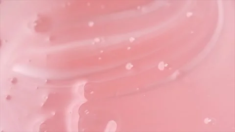 Pearlescent pink liquid soap, shower gel swirl texture, surface of liquid fluid Stock Footage 341894808