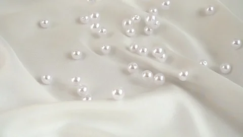 Pearls fall on silk. Slow motion. Stock Footage 126168397