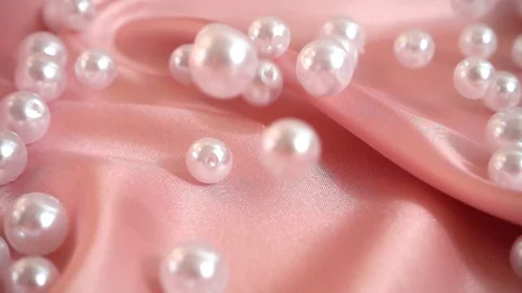 Pearls fall on silk. Slow motion.	 Stock Footage 126168629