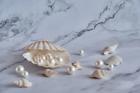 Pearls in a shell on a marble background Stock Photos