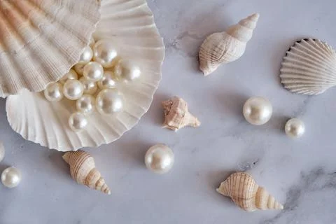 Pearls in a shell on a marble background Stock Photos