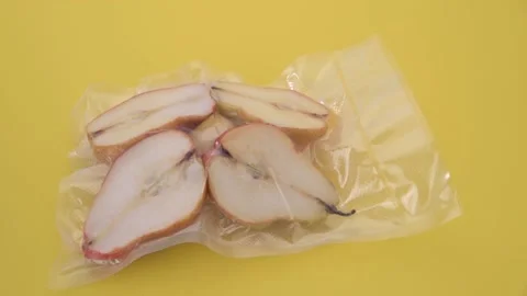 Pears cut in half in vacuum sealed for sous vide cooking, panning shot Stock Footage 154475744