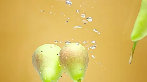 Pears fall floating in water Stock Footage 159303844
