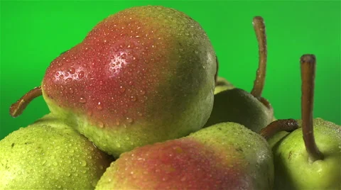 Pears isolated rotating on green background Stock Footage 62407512