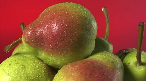 Pears isolated rotating on red background Video stock 62407364